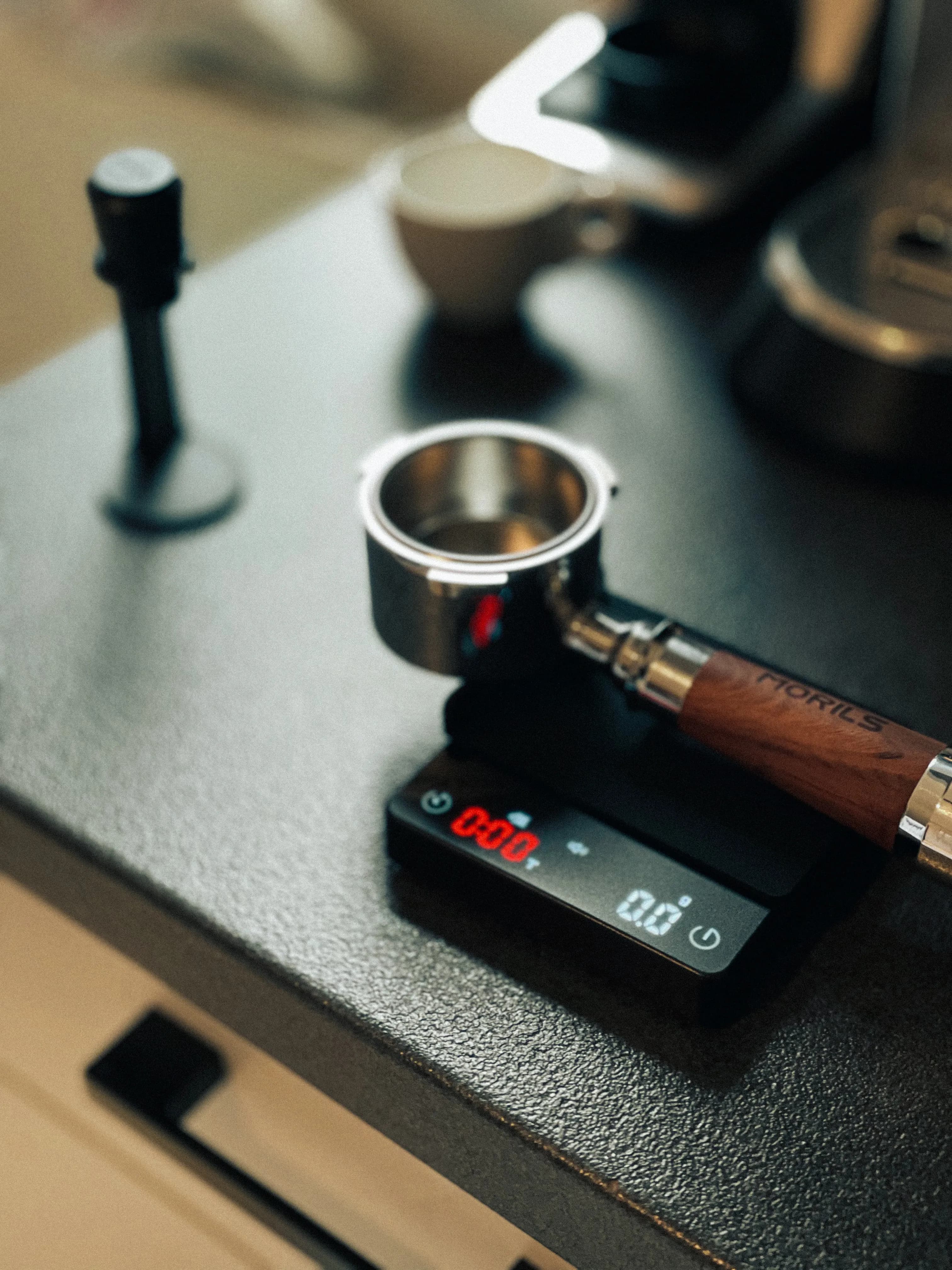 Espresso portafilter resting on a digital coffee scale