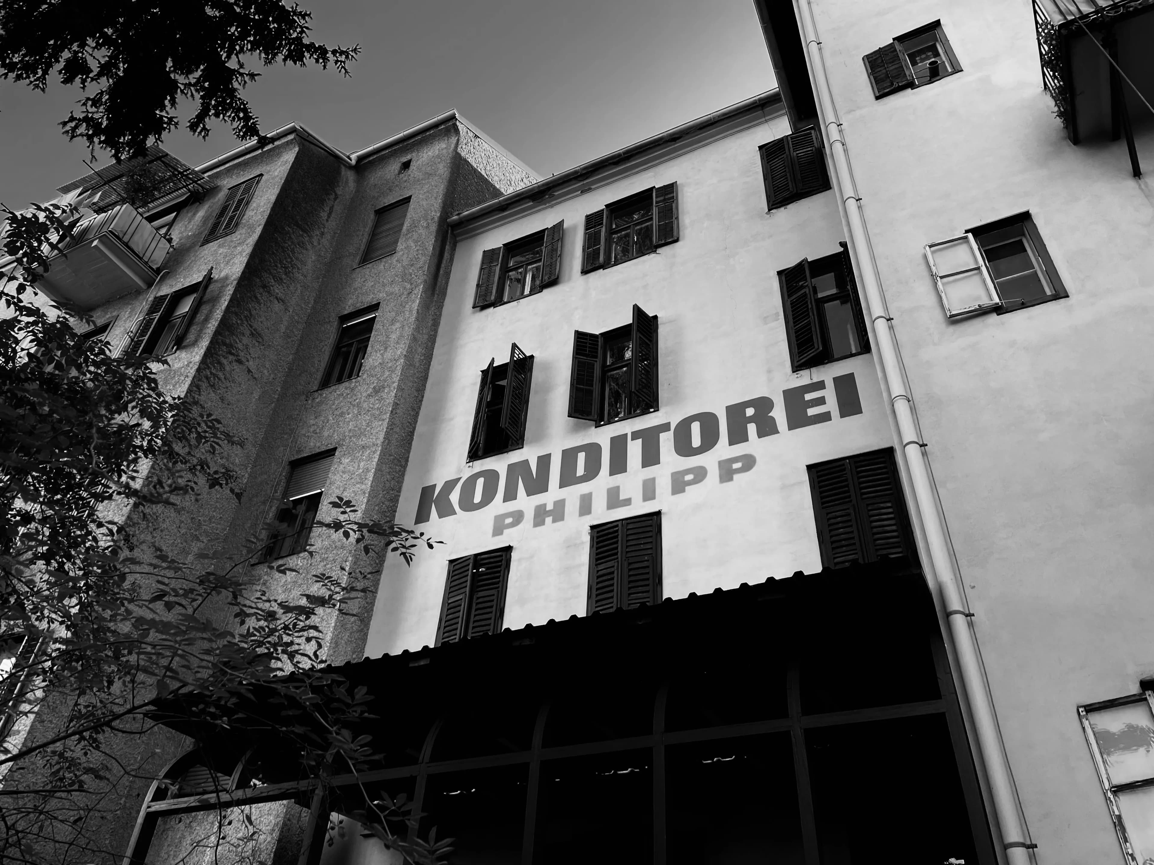 Black-and-white view looking up at a confectionery building