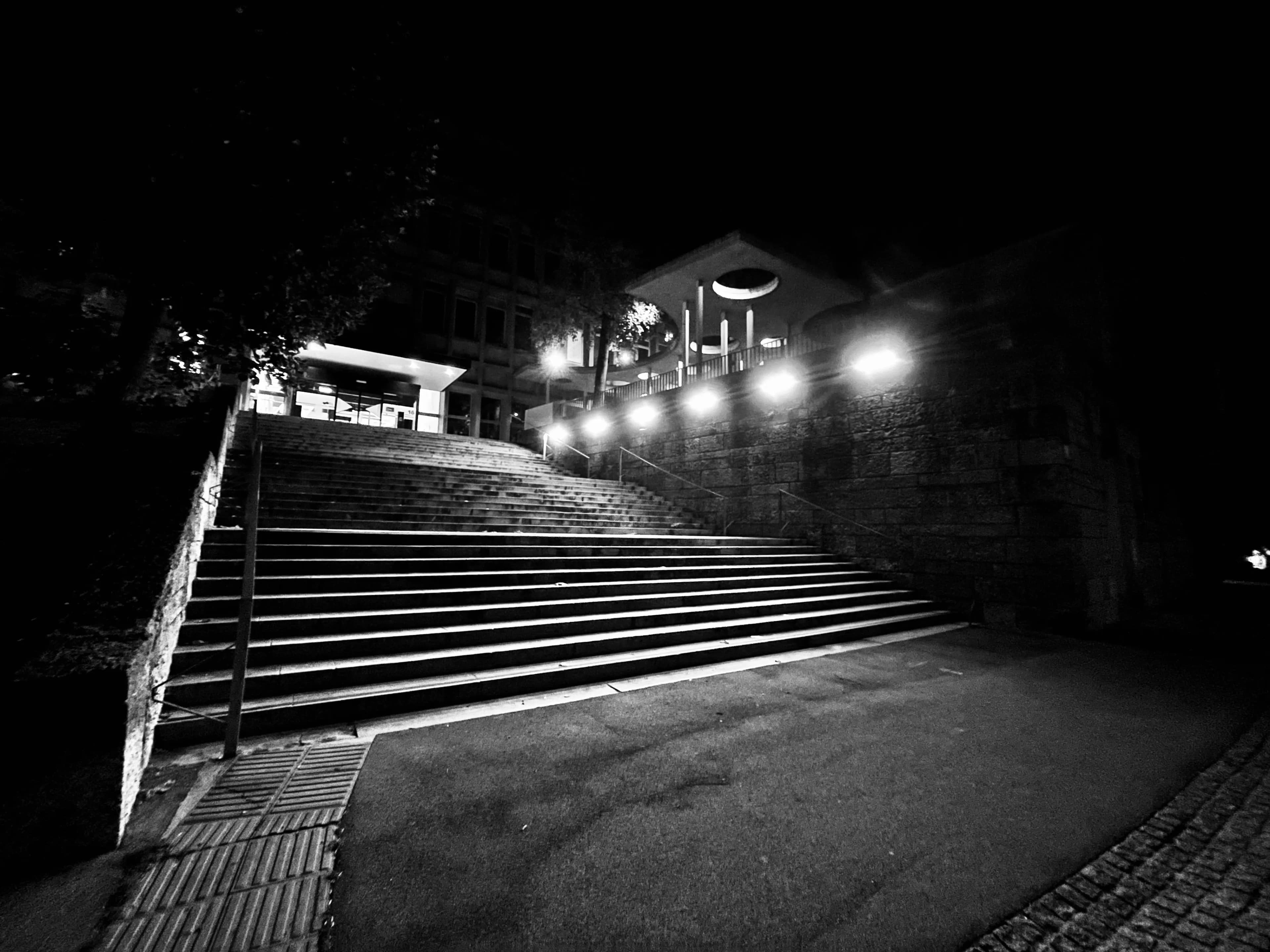 Broad outdoor steps illuminated by streetlights at night