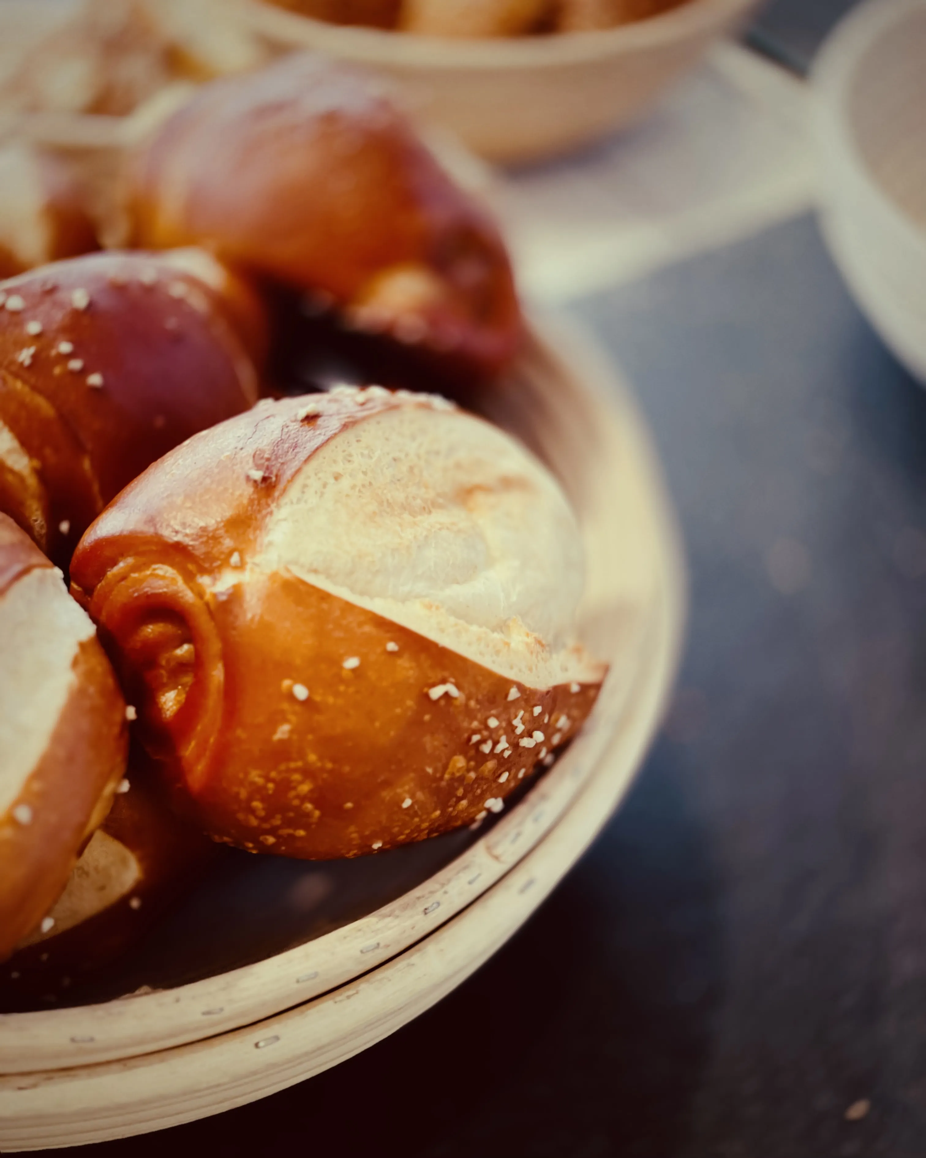Close-up of glossy brown bread rolls piled on a plate