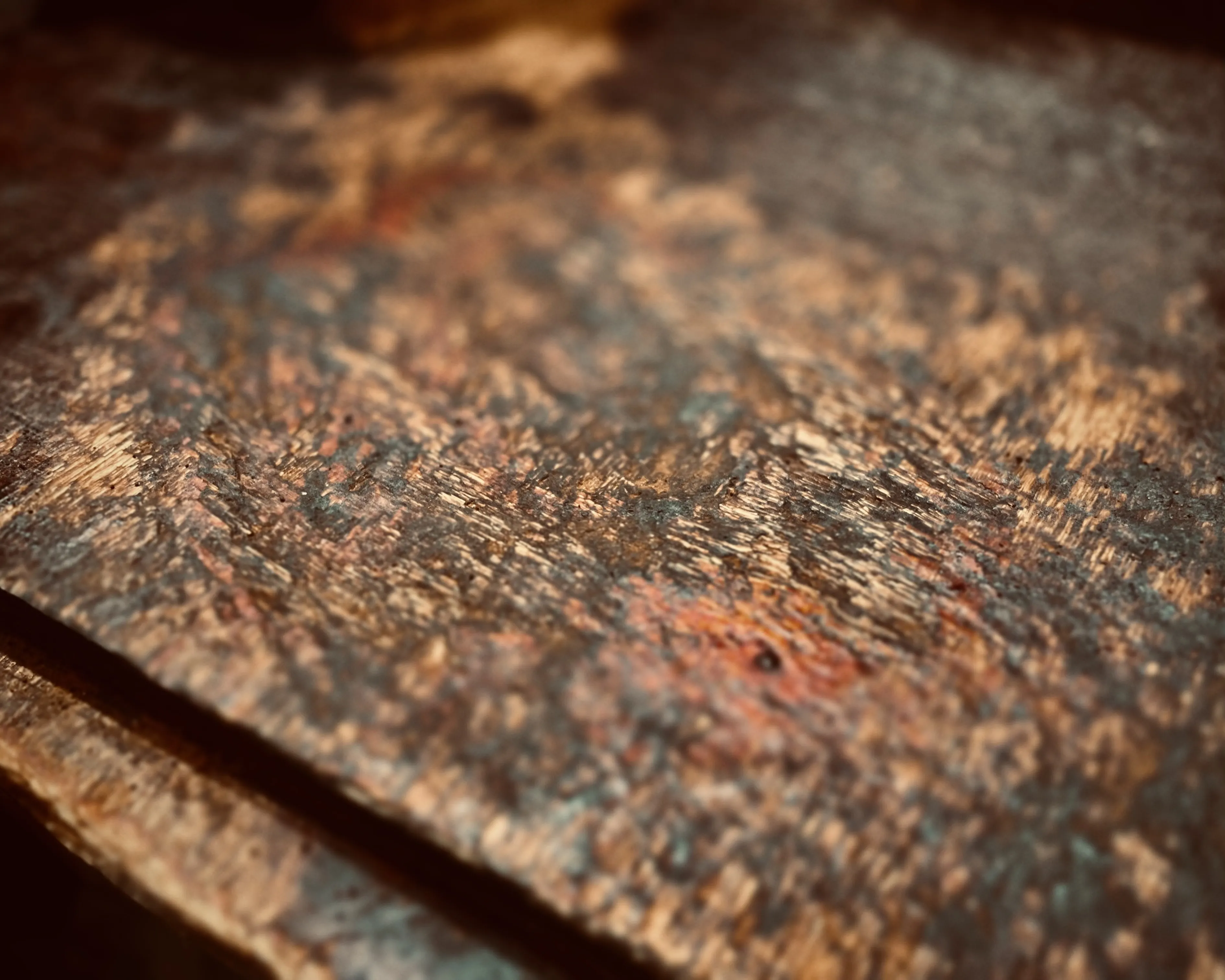 Close-up of textured orange-brown rust on overlapping metal sheets